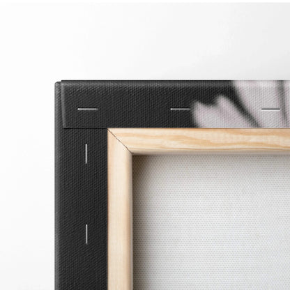 Close-up of stretched canvas corner with wooden frame and black backing for wall art decor.