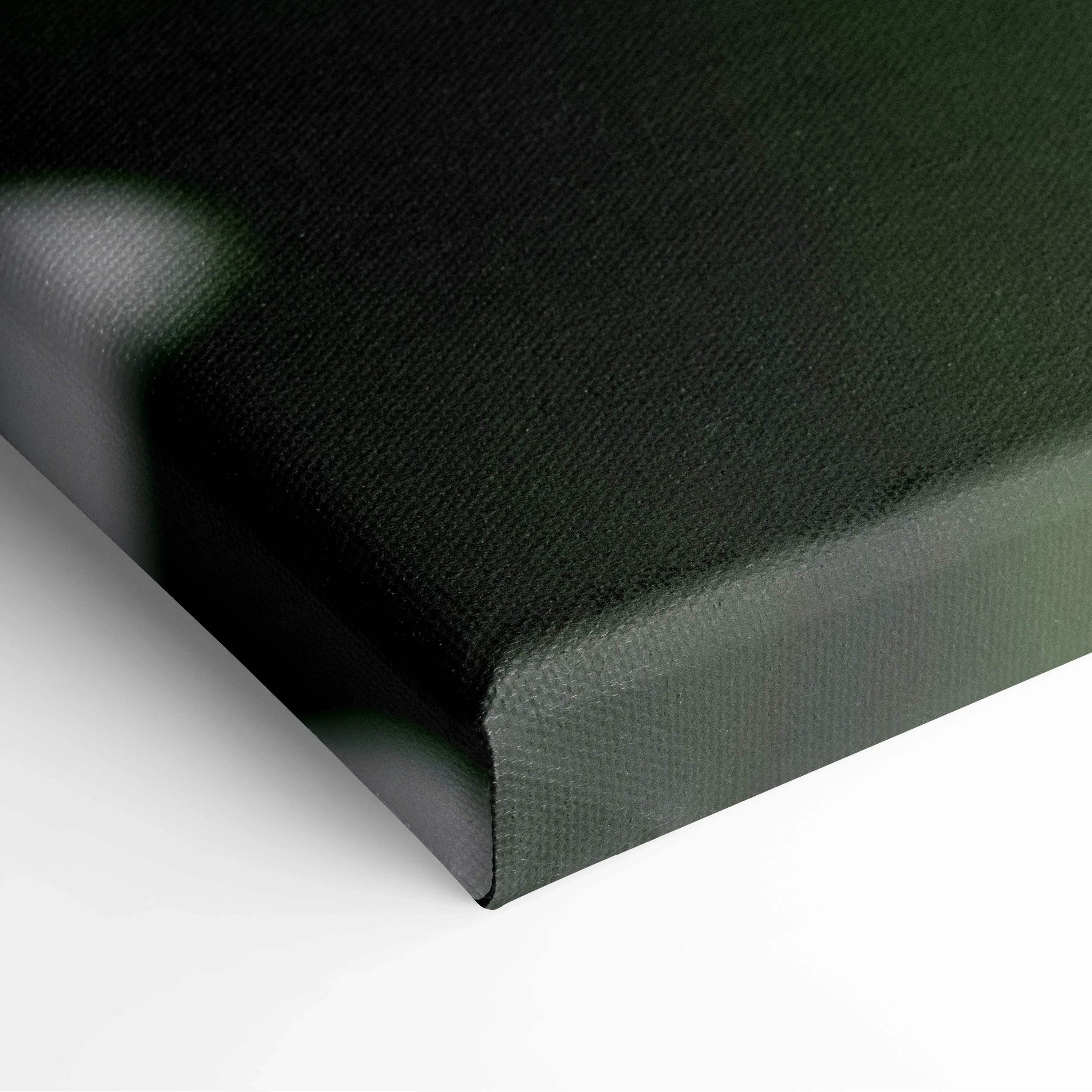 Close-up of wrapped canvas edge in dark green fabric for wall art decor.