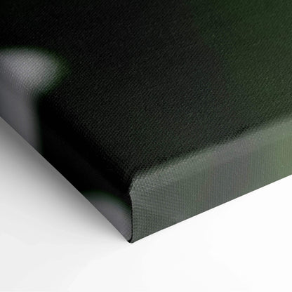Close-up of wrapped canvas edge in dark green fabric for wall art decor.