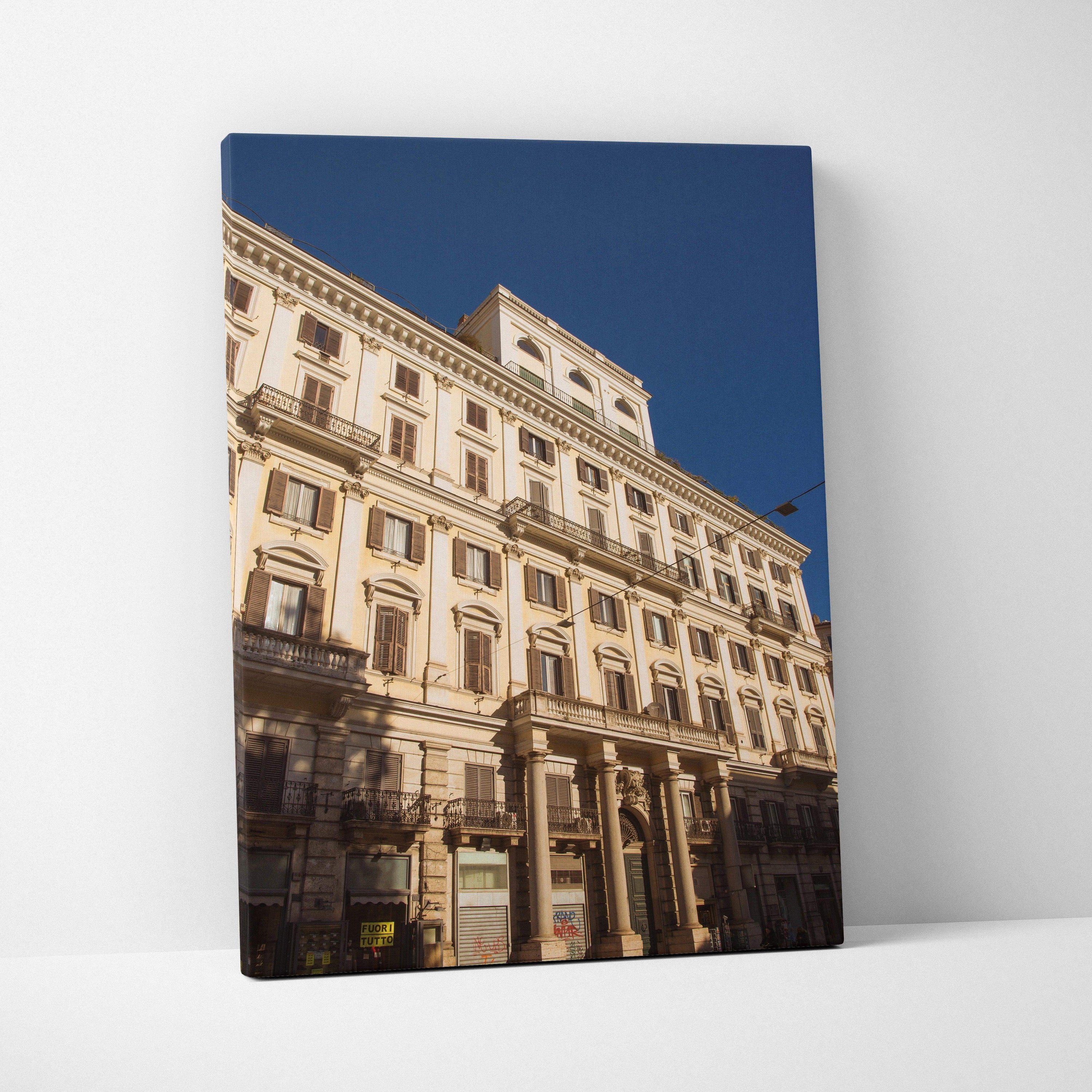Canvas wall art featuring detailed urban architecture of a classic beige building against a clear blue sky.