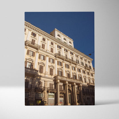 Urban architectural canvas wall art featuring classic multi-story building under clear blue sky.