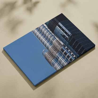 Canvas wall art featuring modern glass skyscraper architecture against a clear blue sky.