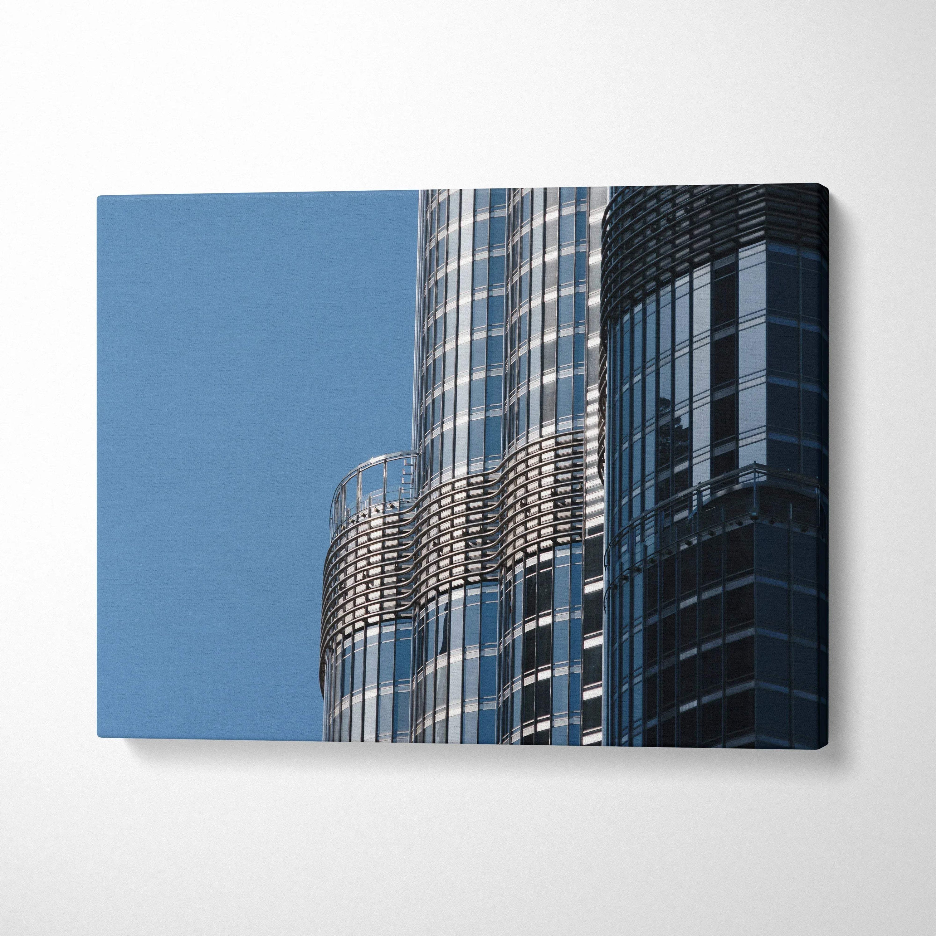 Canvas wall art featuring modern glass building architecture against a clear blue sky.