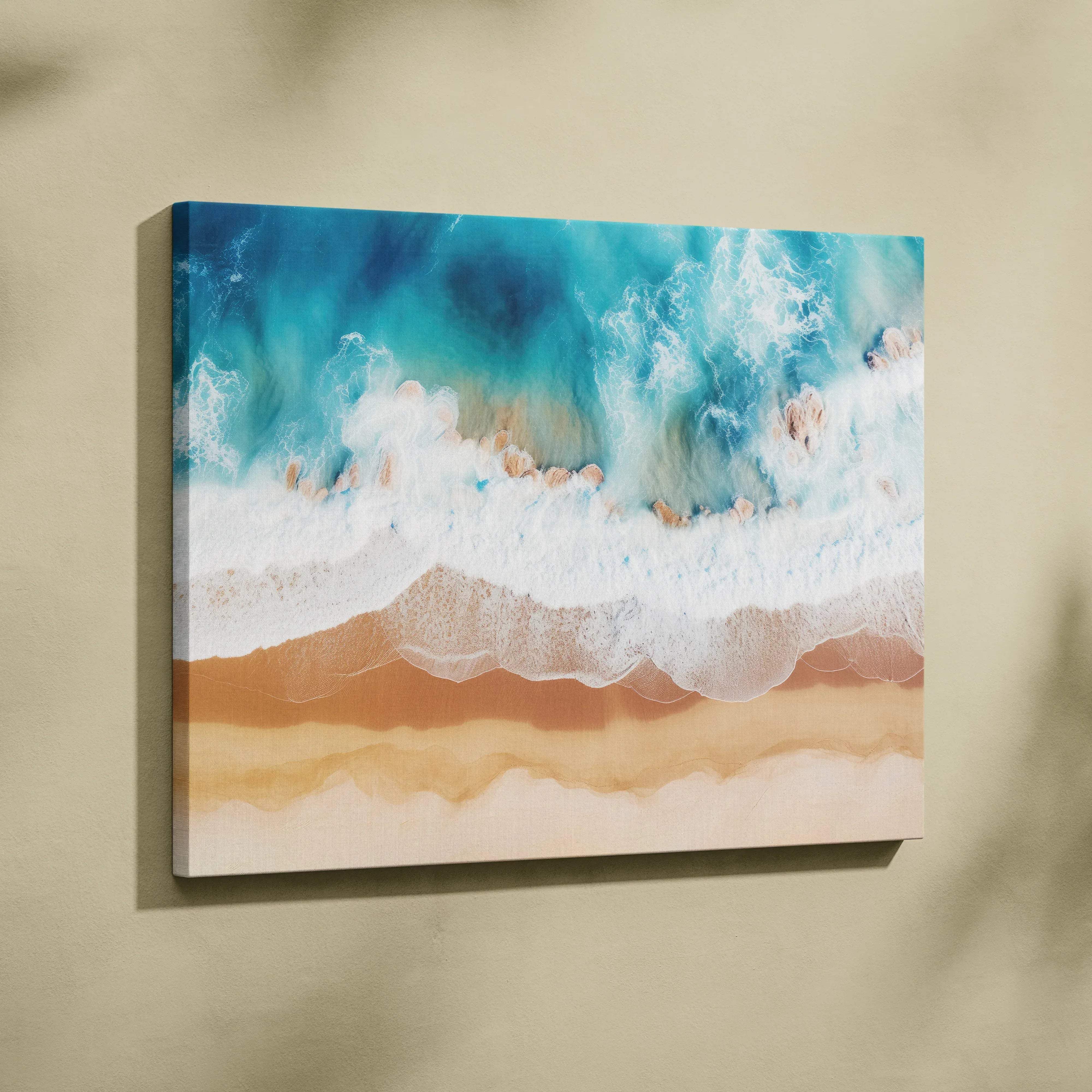 A vibrant canvas wall art featuring turquoise ocean waves crashing on sandy beige beach for calming seaside decor