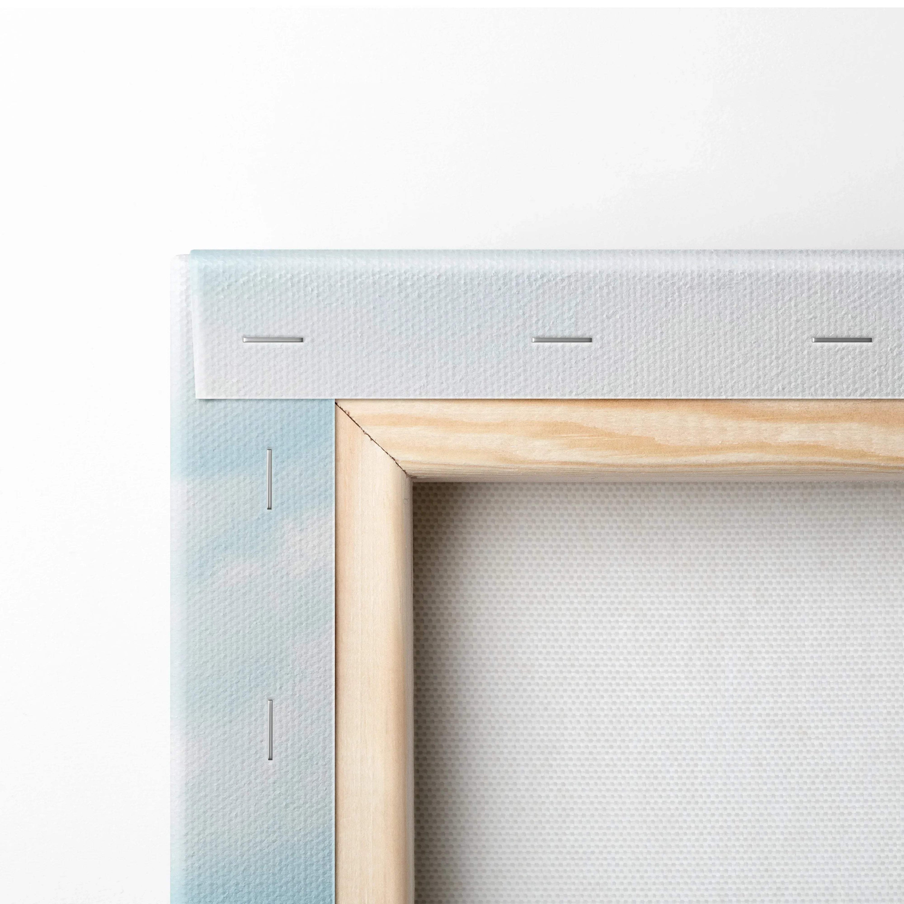 Close-up of stretched canvas art with wooden frame and visible staples on the back for wall art mounting.