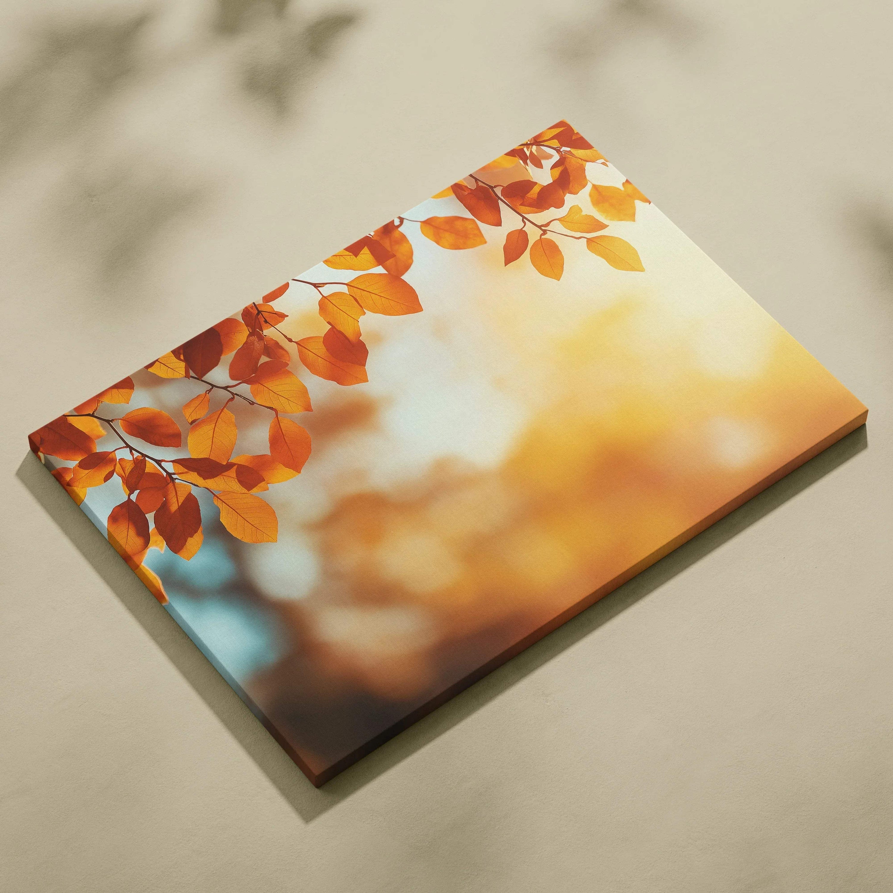 Canvas wall art featuring vibrant autumn leaves in warm orange and golden tones with a soft, blurred nature background.