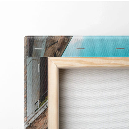 Close-up of museum-quality canvas wall art with wooden frame and architectural digital print in blues and browns.
