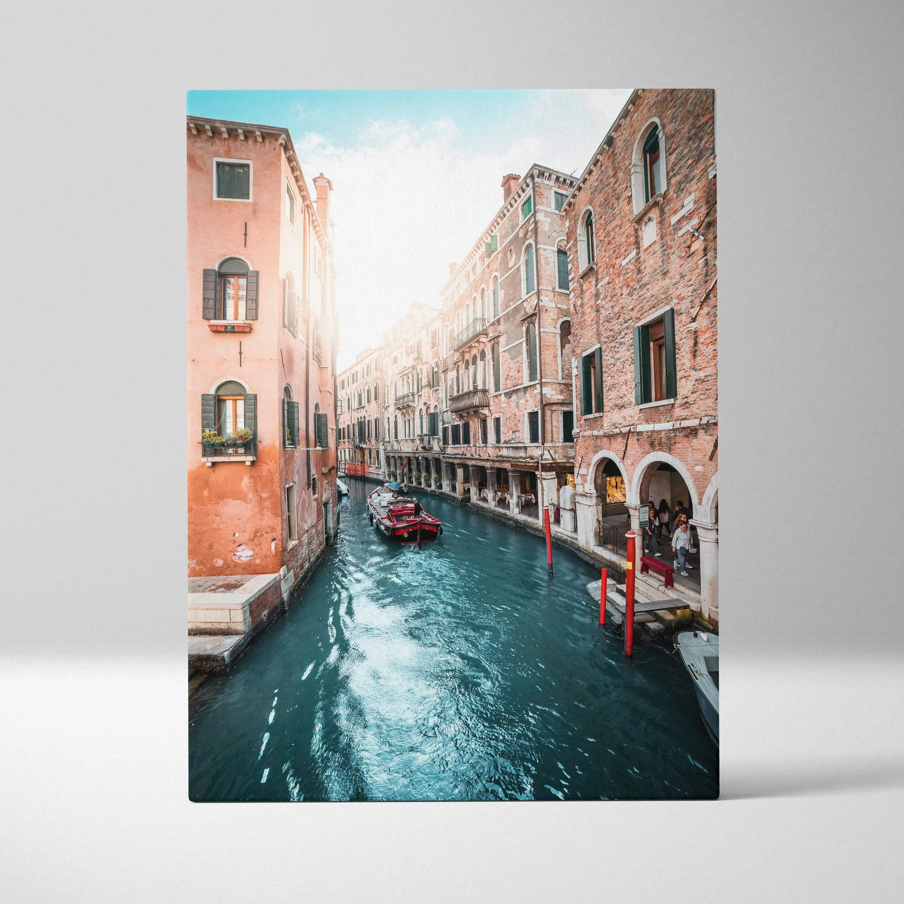 Vertical canvas wall art featuring a sunlit Venetian canal with historic brick buildings and gondolas.