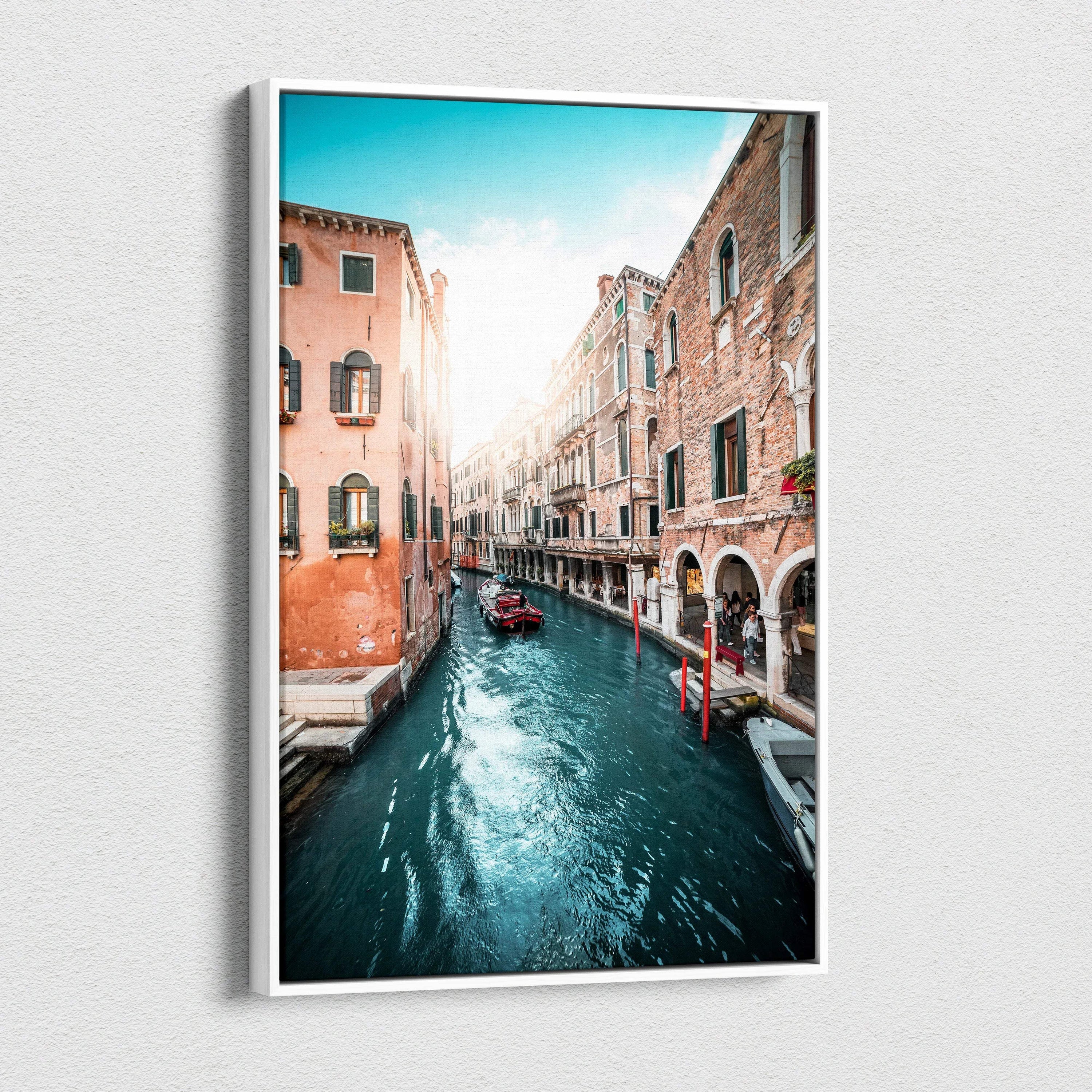 Vertical canvas wall art featuring a sunlit canal flanked by historic brick buildings with arched windows and balconies.