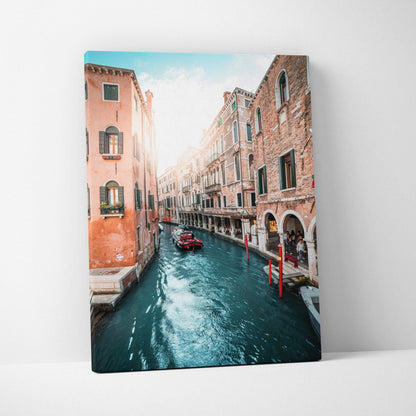Canvas wall art featuring a vibrant digital cityscape of canal buildings with warm terracotta tones and turquoise water.