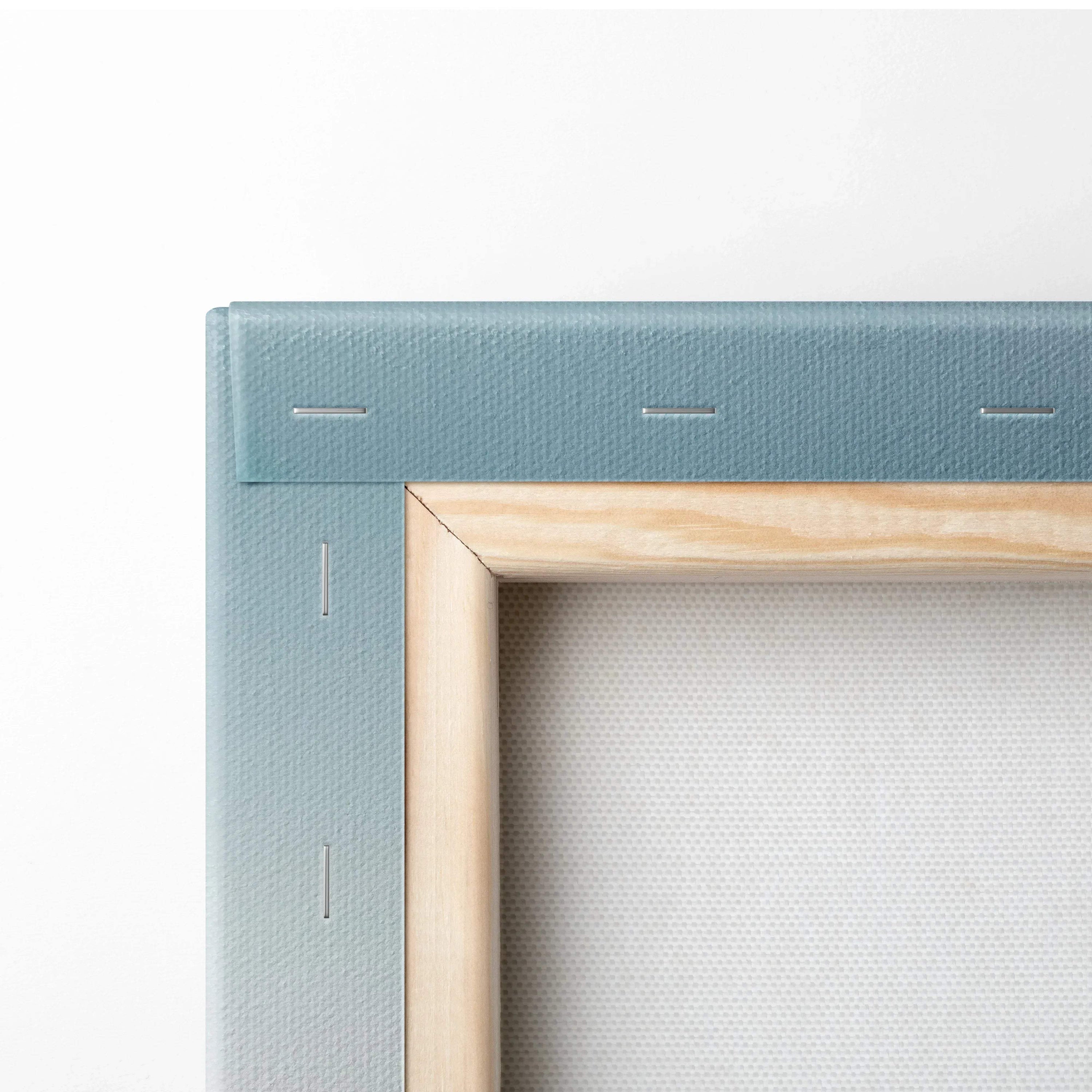 Close-up of stretched canvas corner with wooden frame and teal fabric backing for wall art.
