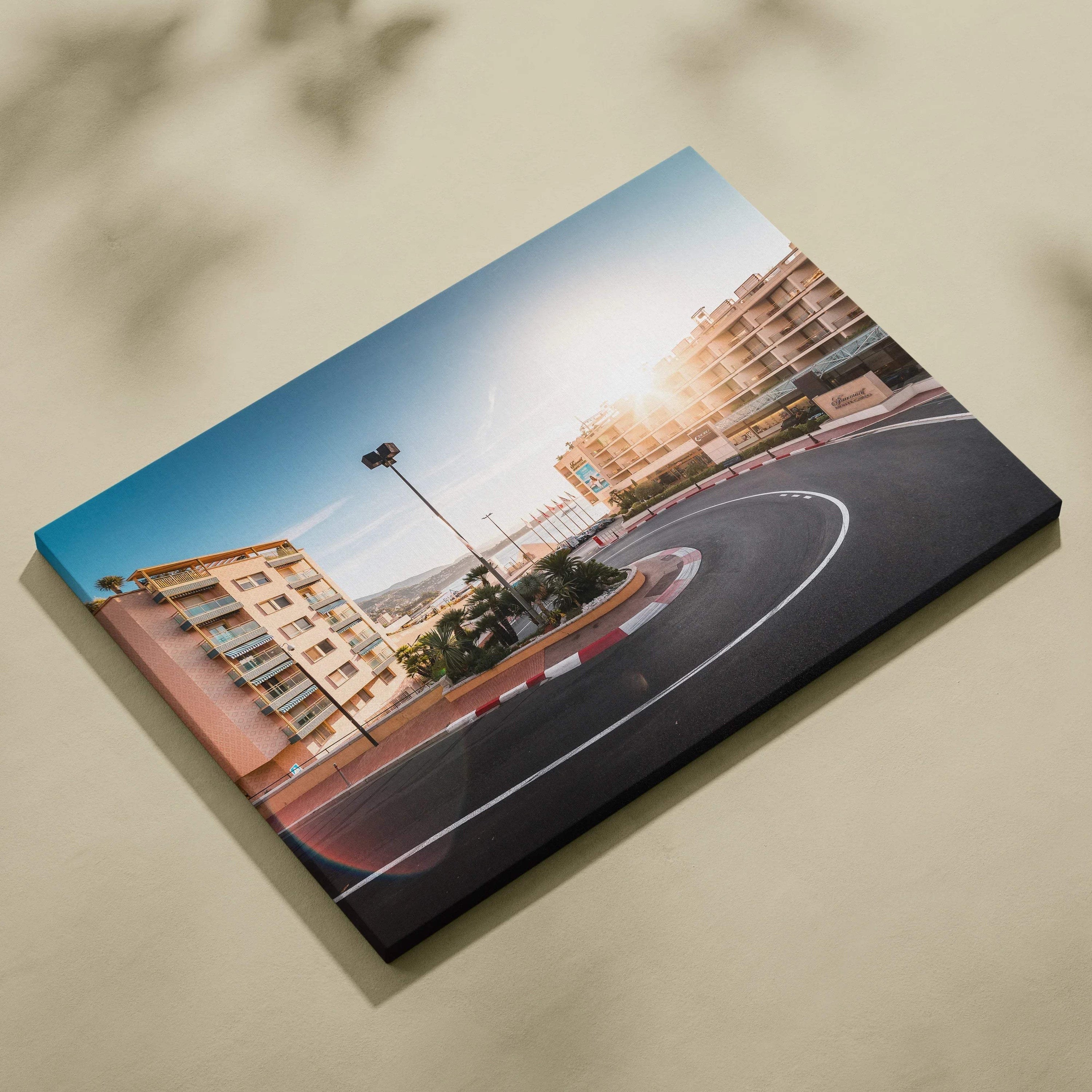 Canvas wall art featuring a curved Monaco F1 street circuit hairpin turn framed by urban buildings under a clear sky.
