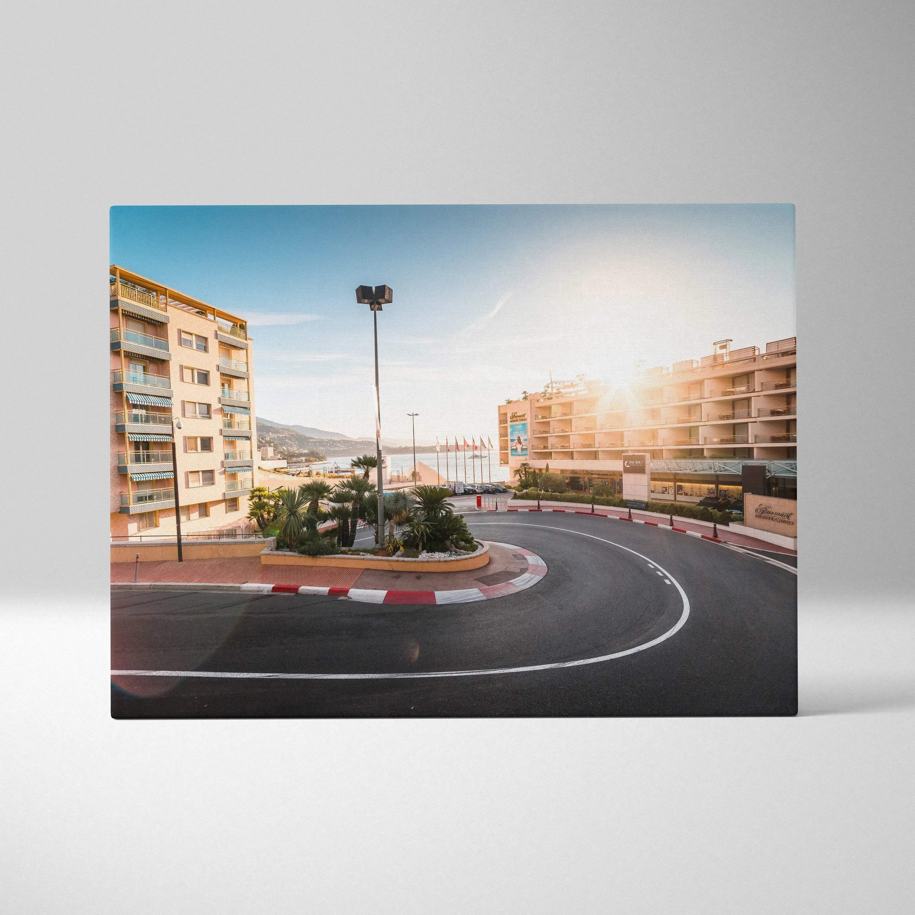 Canvas wall art featuring a sunlit Monaco F1 track hairpin turn with surrounding buildings and clear blue sky.