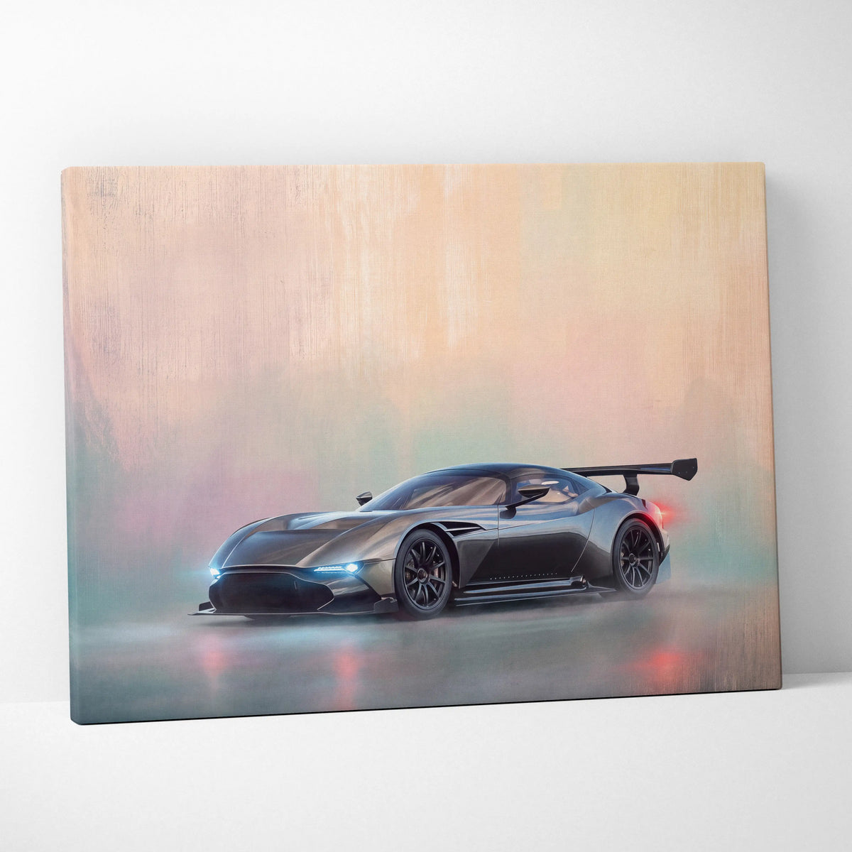 A matte black aston martin valkyrie race car canvas art print with glowing blue headlights and red taillights
