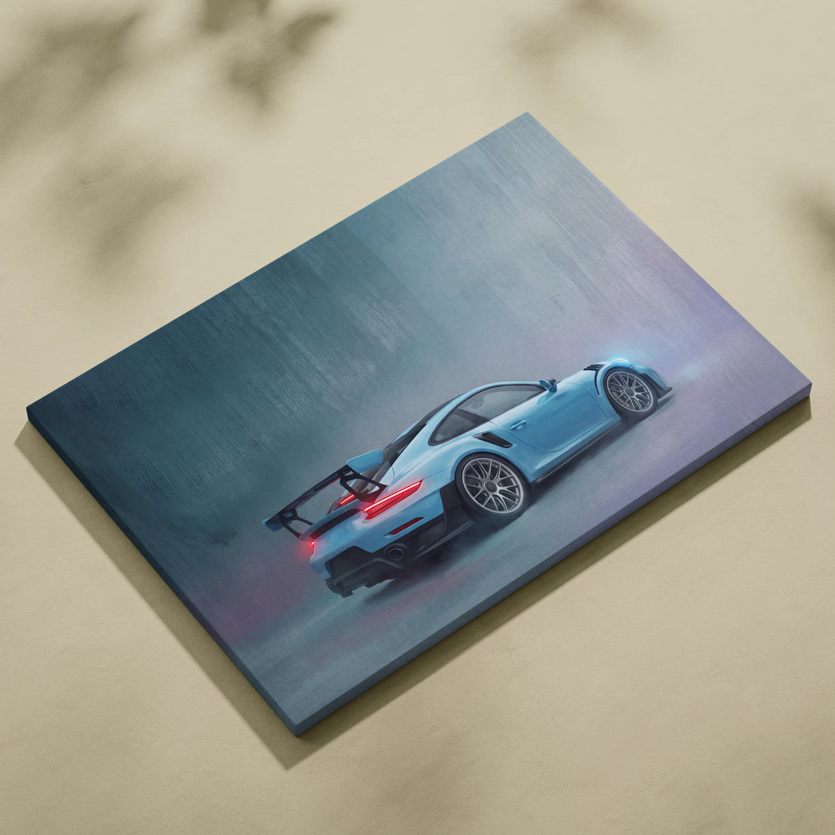 A canvas print of a light blue Porsche 911 GT2 RS in motion with glowing rear lights on misty background