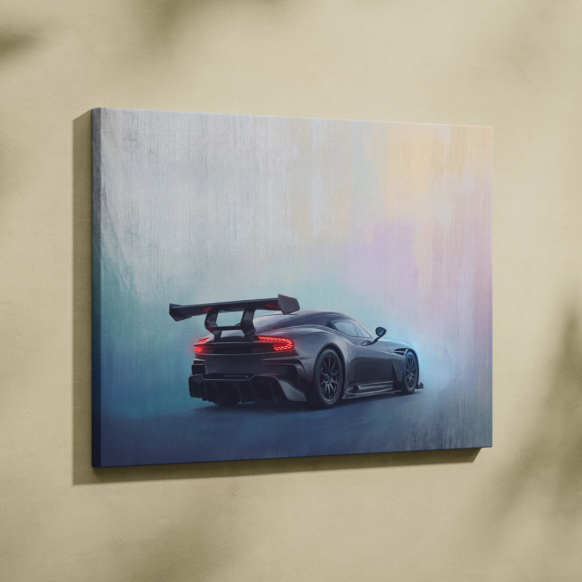 Aston Martin Vulcan inspired canvas art of a sleek black sports car with rear spoiler and glowing red taillights