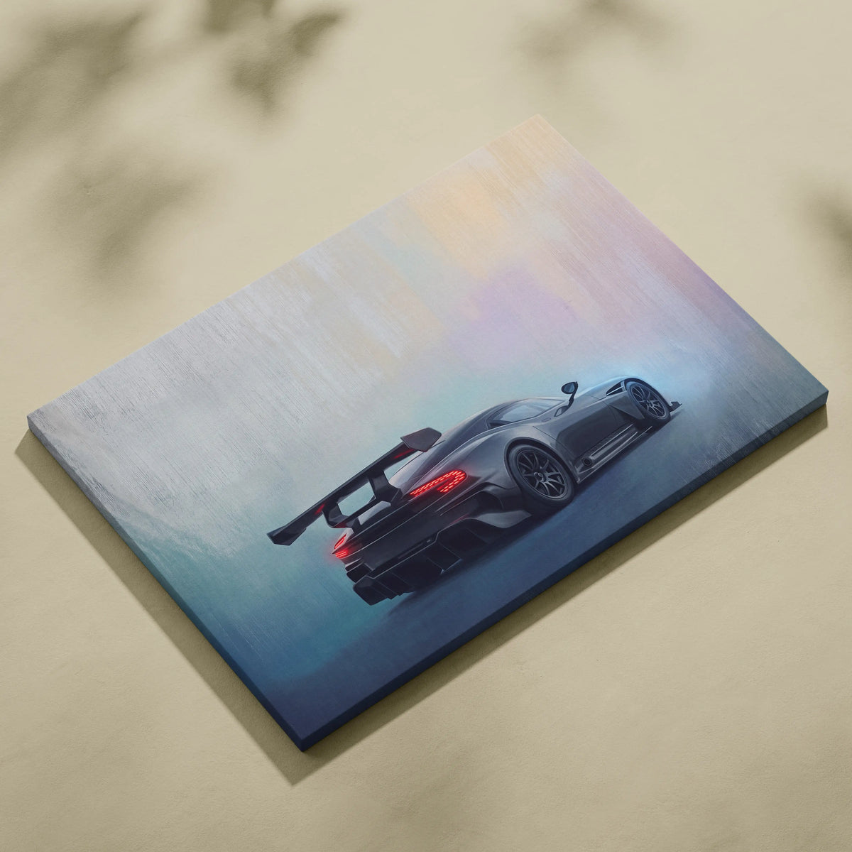 Aston Martin Vulcan inspired canvas art showing the back of a sleek black sports car with glowing red taillights
