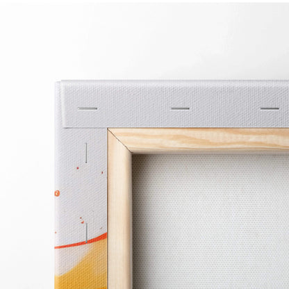Close-up of stretched canvas corner with visible staples, natural wood frame, and abstract orange and red paint splashes on.