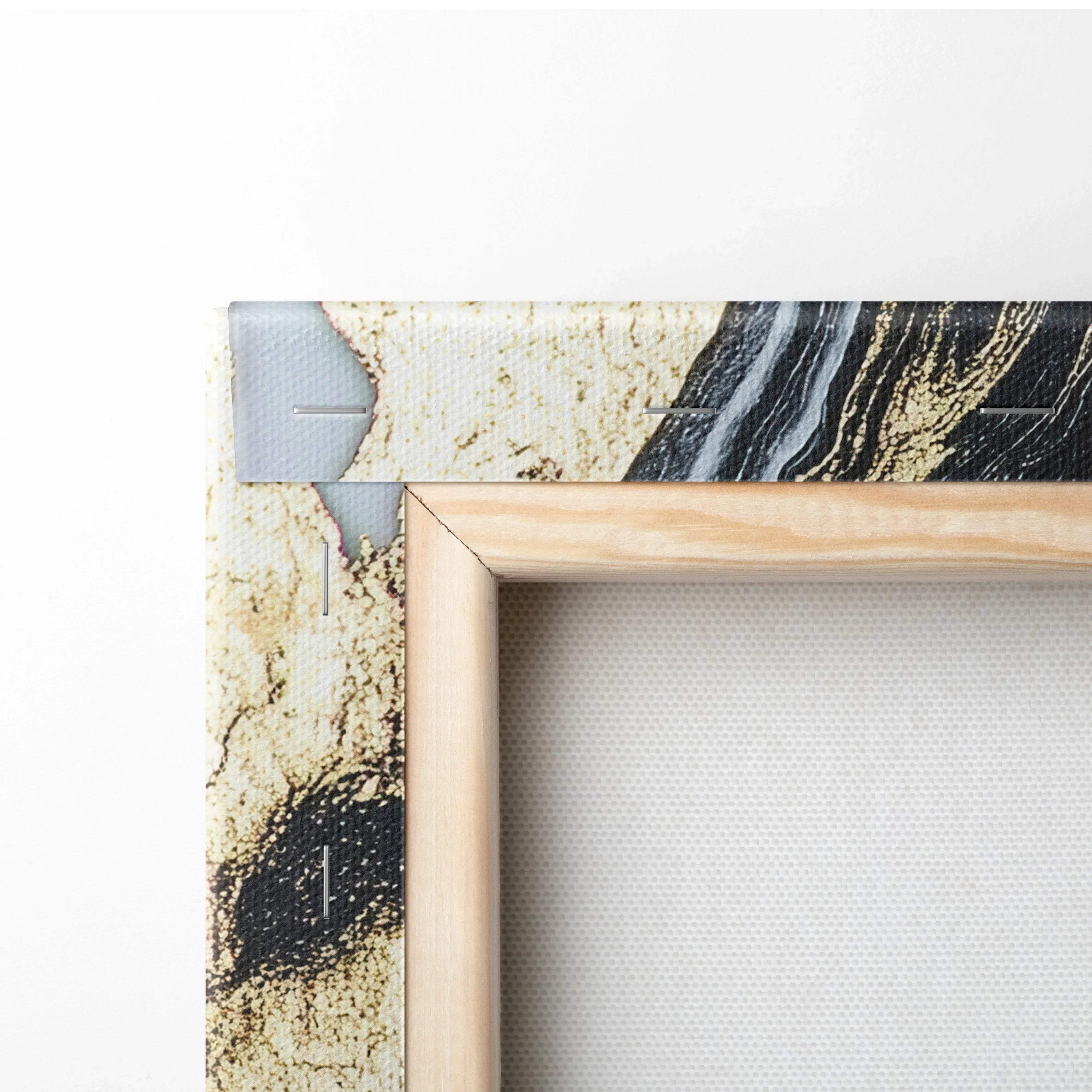 Corner of a stretched canvas print with abstract black, beige, and gray digital art framed by natural wood stretcher bars.