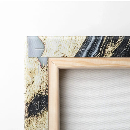 Corner of a stretched canvas print with abstract black, beige, and gray digital art framed by natural wood stretcher bars.