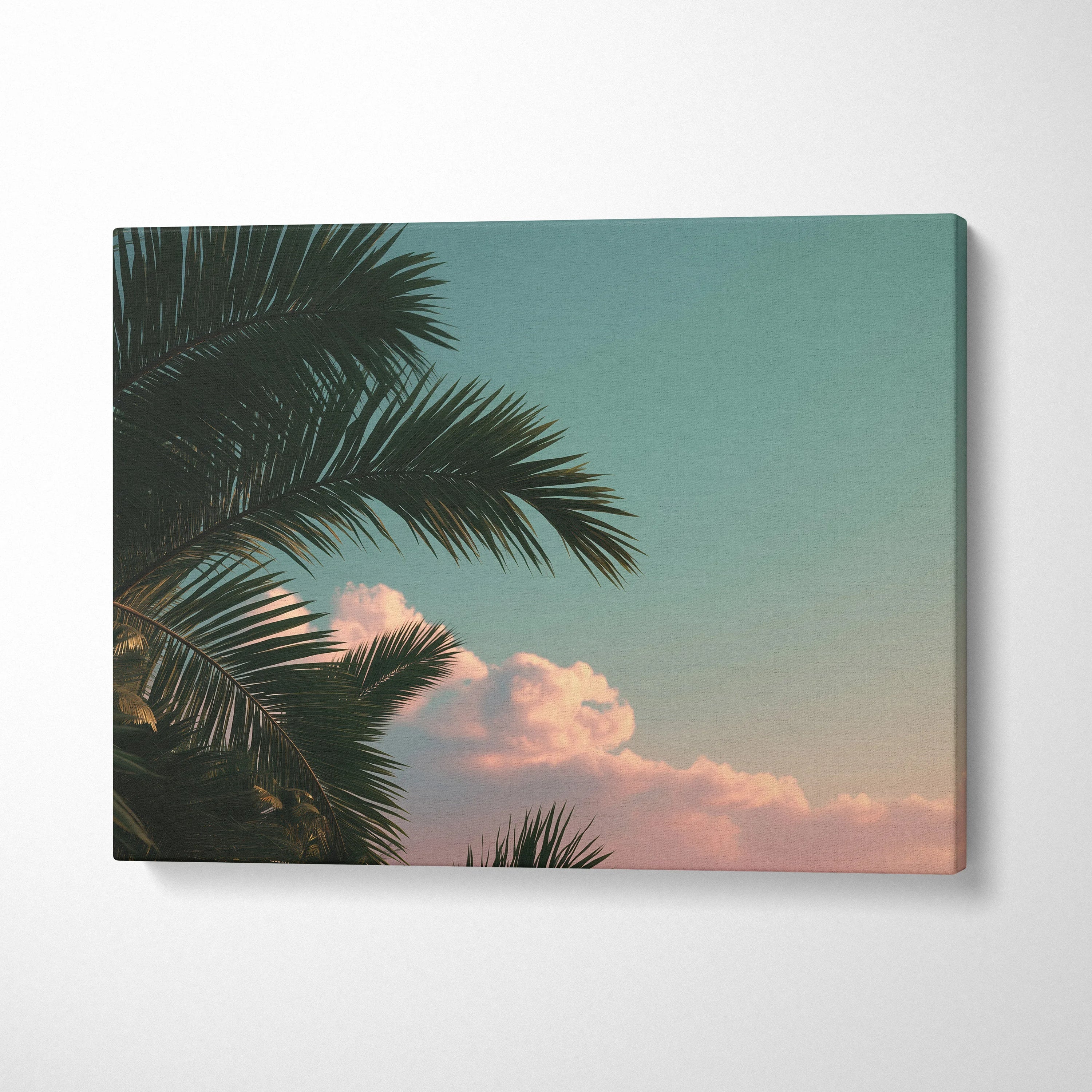 Canvas wall art featuring tropical palm trees with soft clouds against a pastel sky for decor.