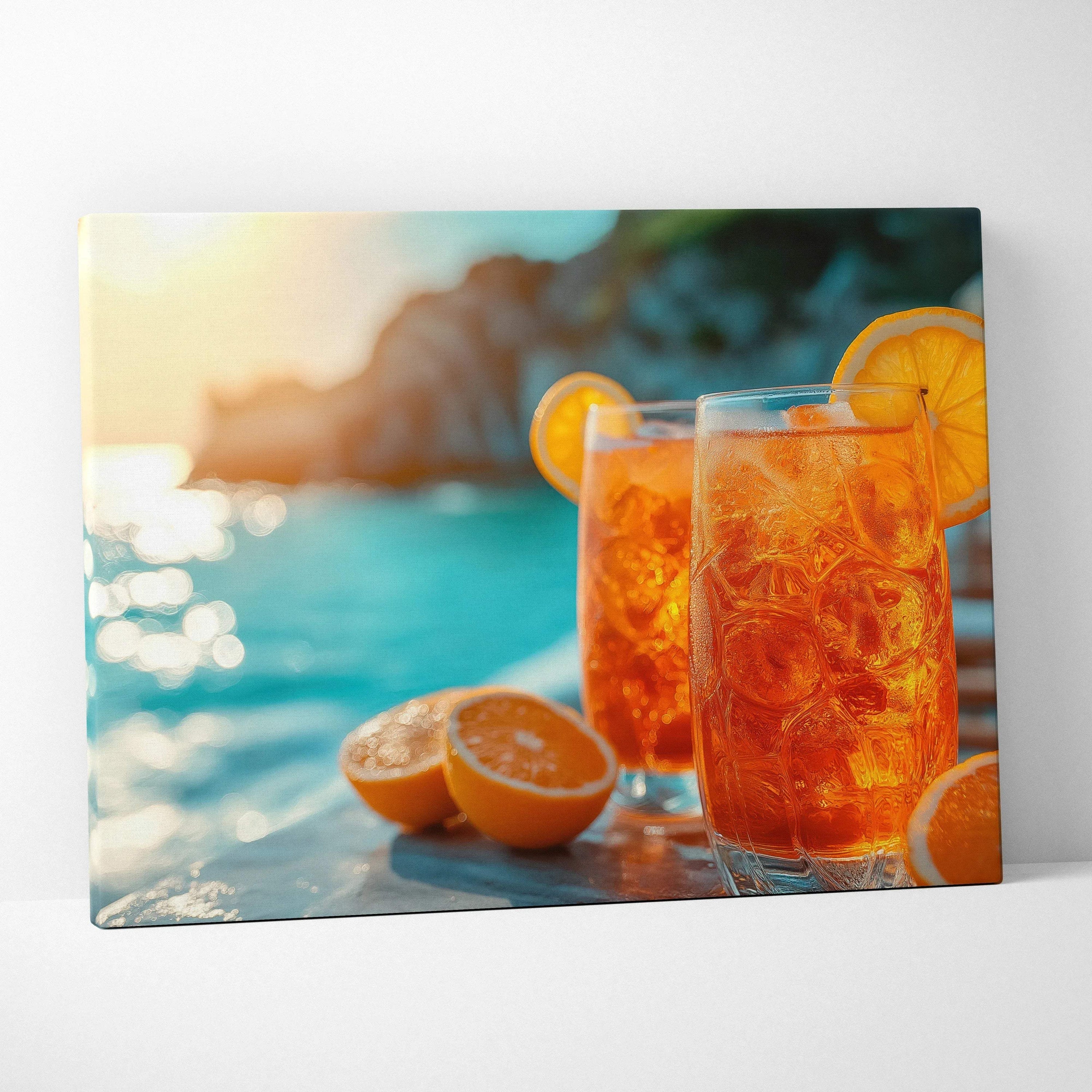 Canvas wall art featuring two vibrant orange Aperol drinks with ice and orange slices by a sunlit blue water background.