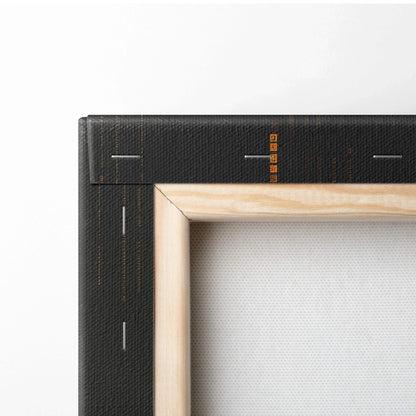 Close-up of wooden frame corner with black canvas wrap featuring orange and white abstract lines on digital canvas wall art.