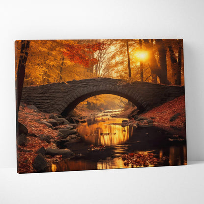 Autumn foliage canvas wall art with vibrant red, orange, and gold leaves and a stone bridge over a stream at sunset.