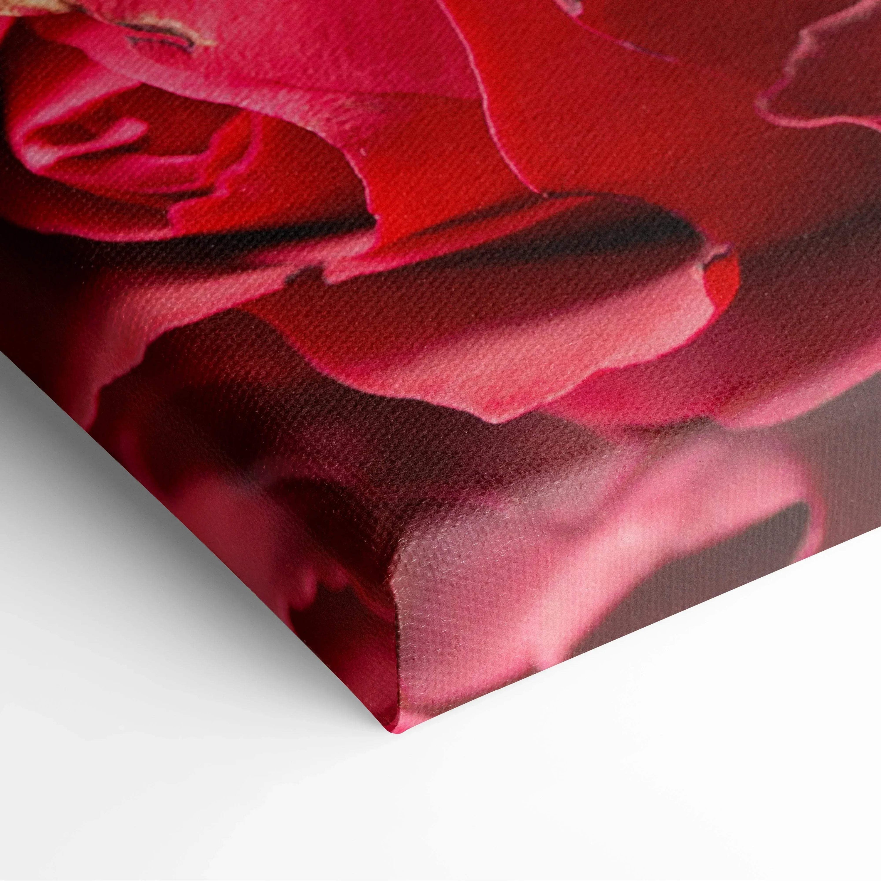 Close-up of canvas wall art featuring vibrant red rose petals with delicate texture and rich color depth.
