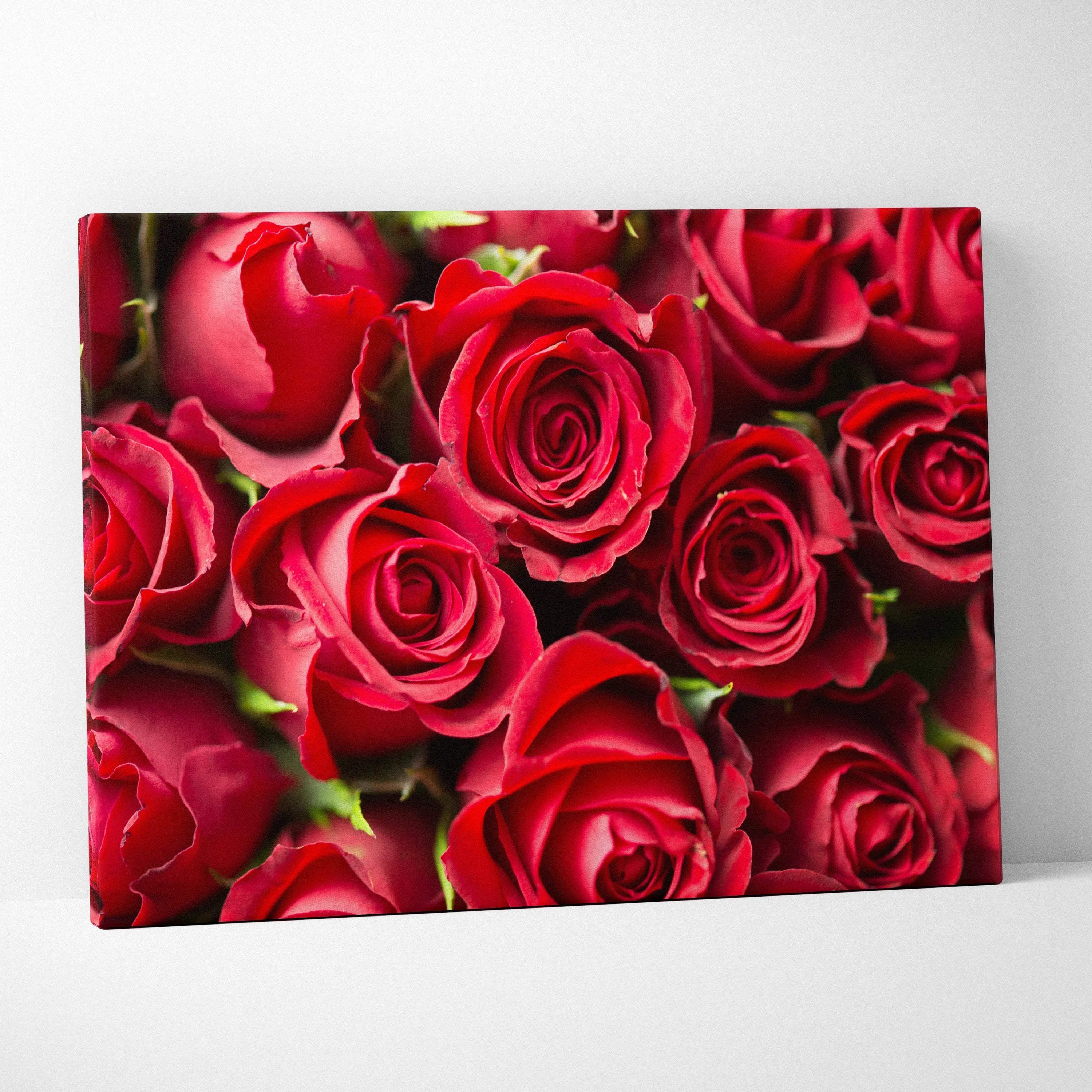 Canvas wall art featuring vibrant red roses with detailed petals and lush green stems, perfect for floral decor.