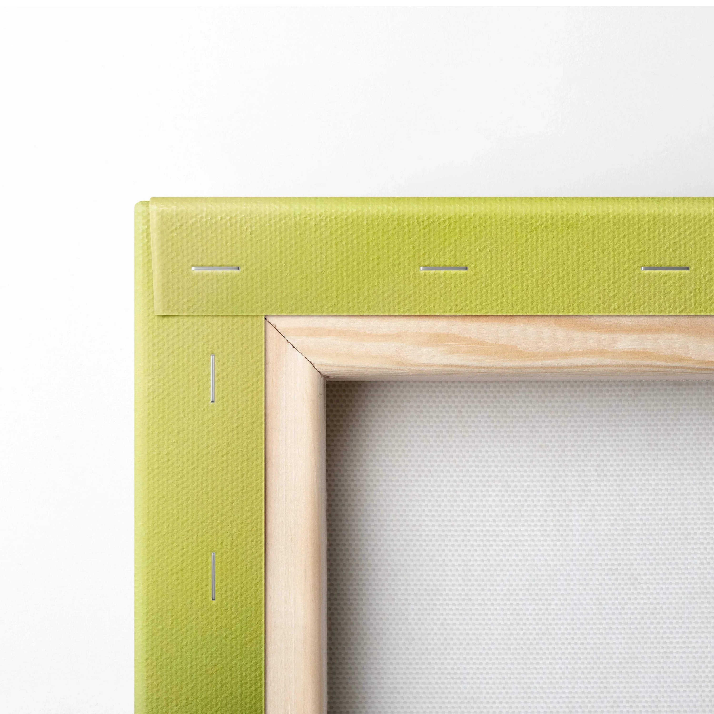 Close-up of stretched canvas with light green fabric edges and natural wood frame backing for wall art decor.