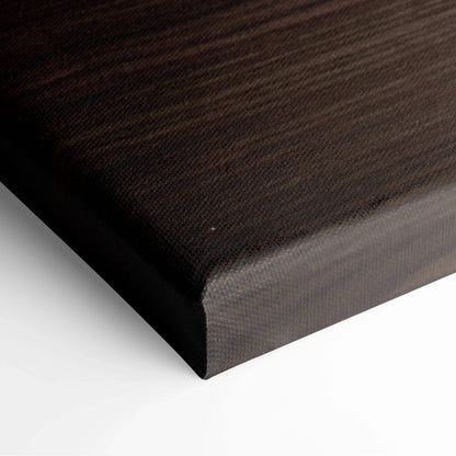Close-up of canvas wall art corner with dark woodgrain texture and smooth black edges.