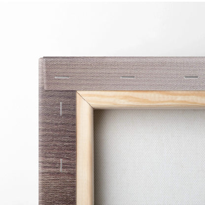 Close-up of canvas art print stretcher bar with stapled beige fabric and wooden frame corner.