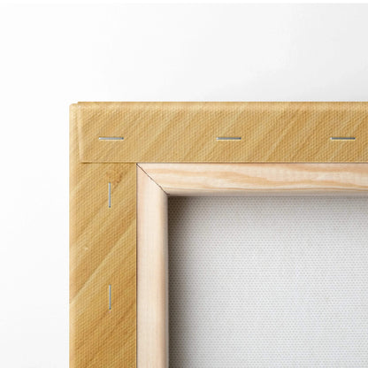 Close-up of wooden stretcher bars with staple-secured edges on the back of a blank white canvas wall art panel.