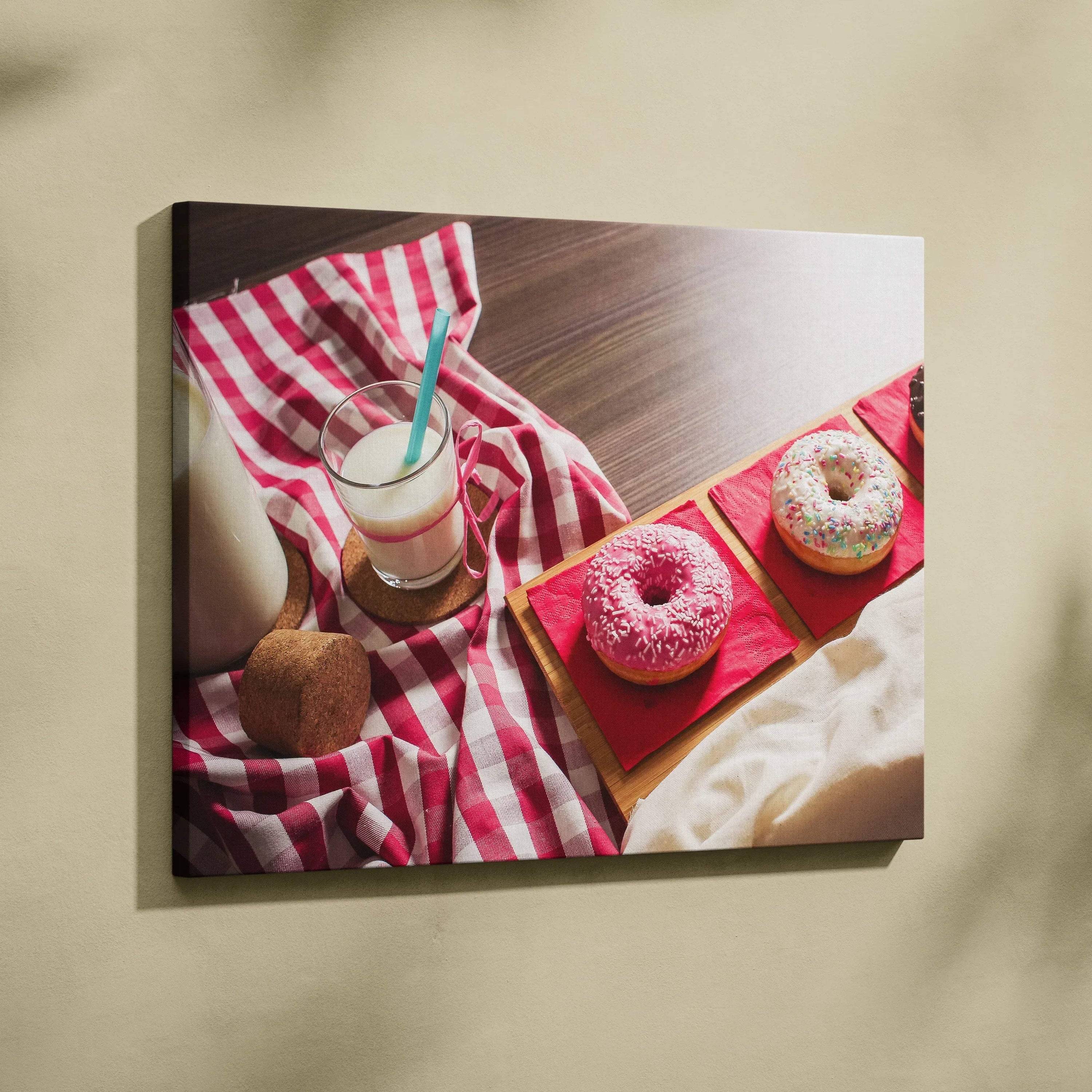 Canvas wall art featuring three colorful frosted donuts with sprinkles on a red tray, next to a glass of milk with a striped