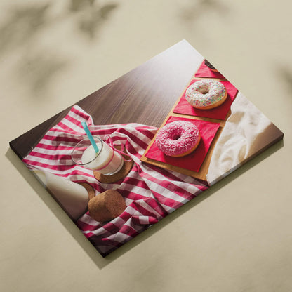 High-resolution canvas wall art featuring colorful sprinkled donuts and a glass of milk on a red-striped cloth, vibrant food