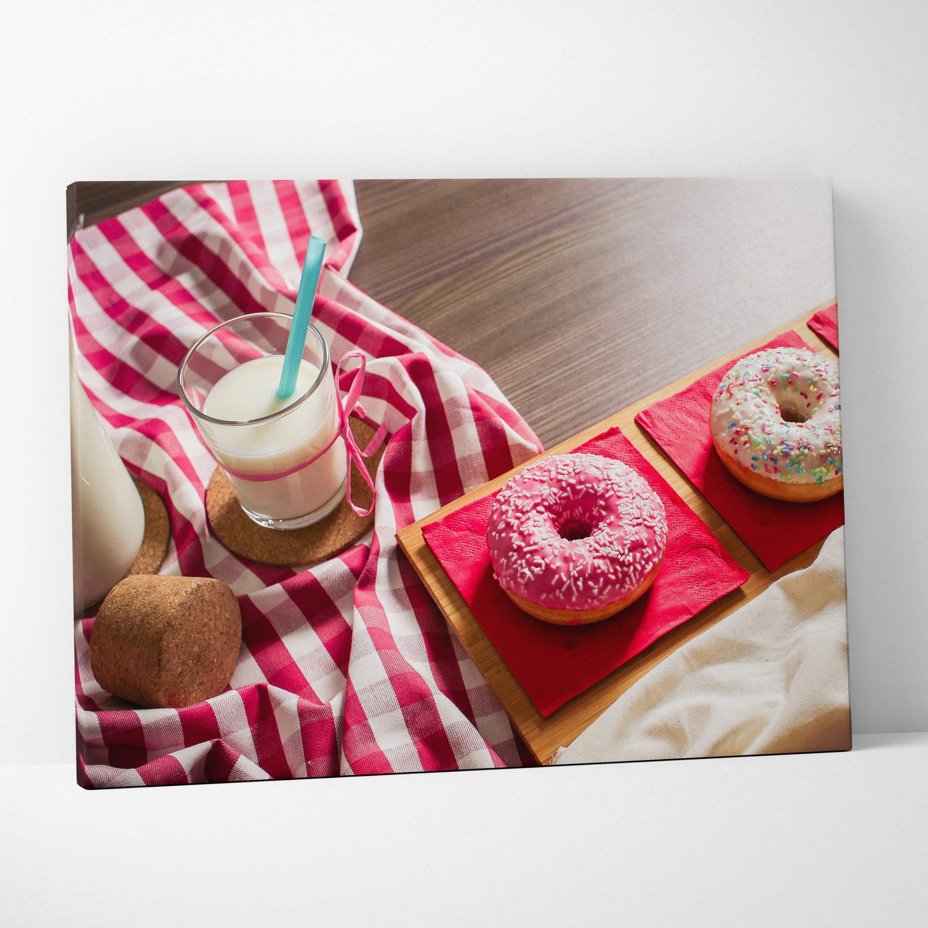 Canvas wall art featuring two colorful sprinkled donuts on red plates beside a glass of milk with a straw and a coconut on a