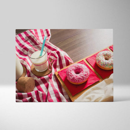 Canvas wall art featuring three colorful donuts with pink and white icing on wooden plates, styled with a checkered red and.