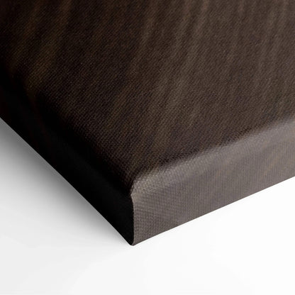 Close-up of wrapped canvas corner with textured black fabric and tight, smooth edges.