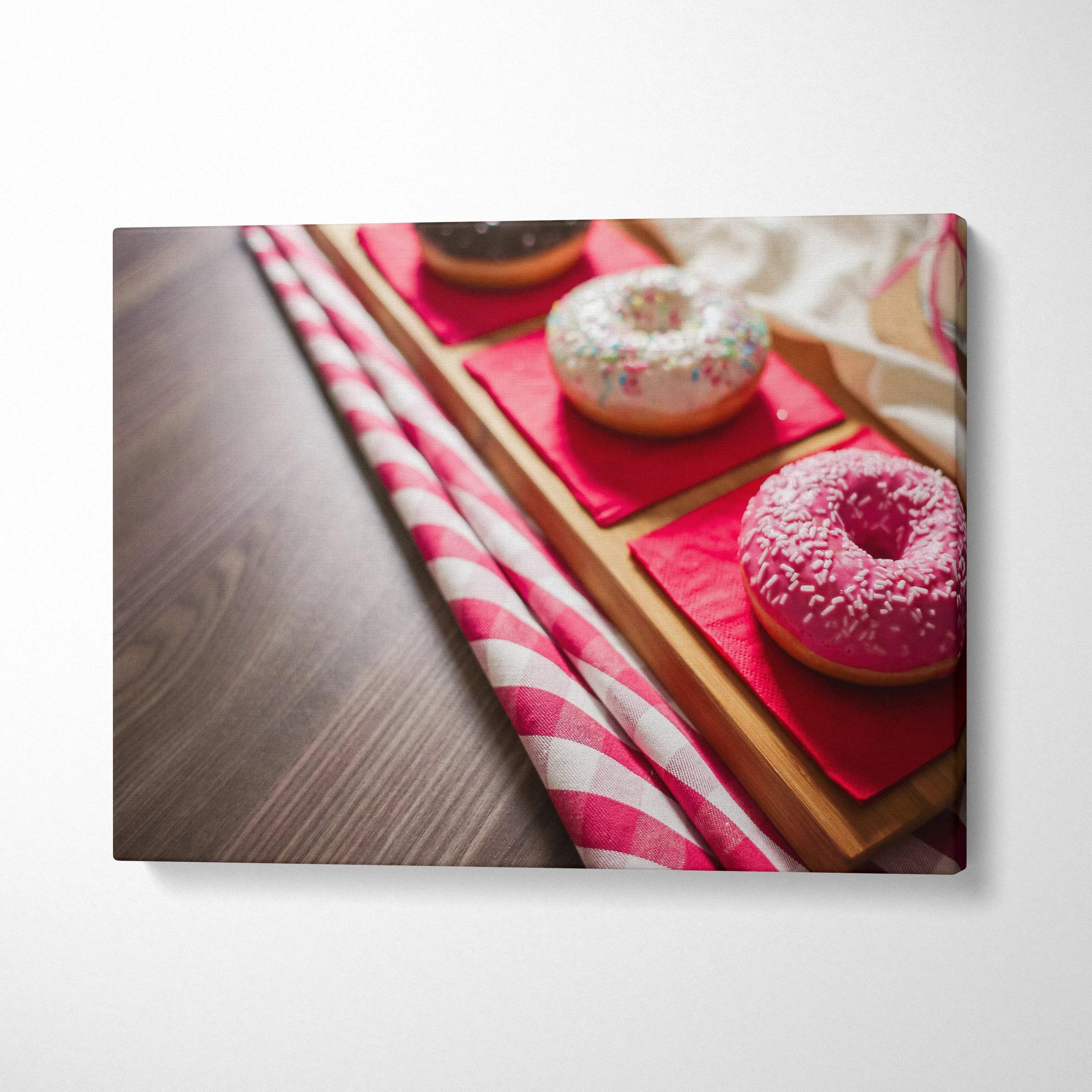 Vibrant canvas wall art featuring glazed donuts with colorful sprinkles on wooden trays, perfect decor.
