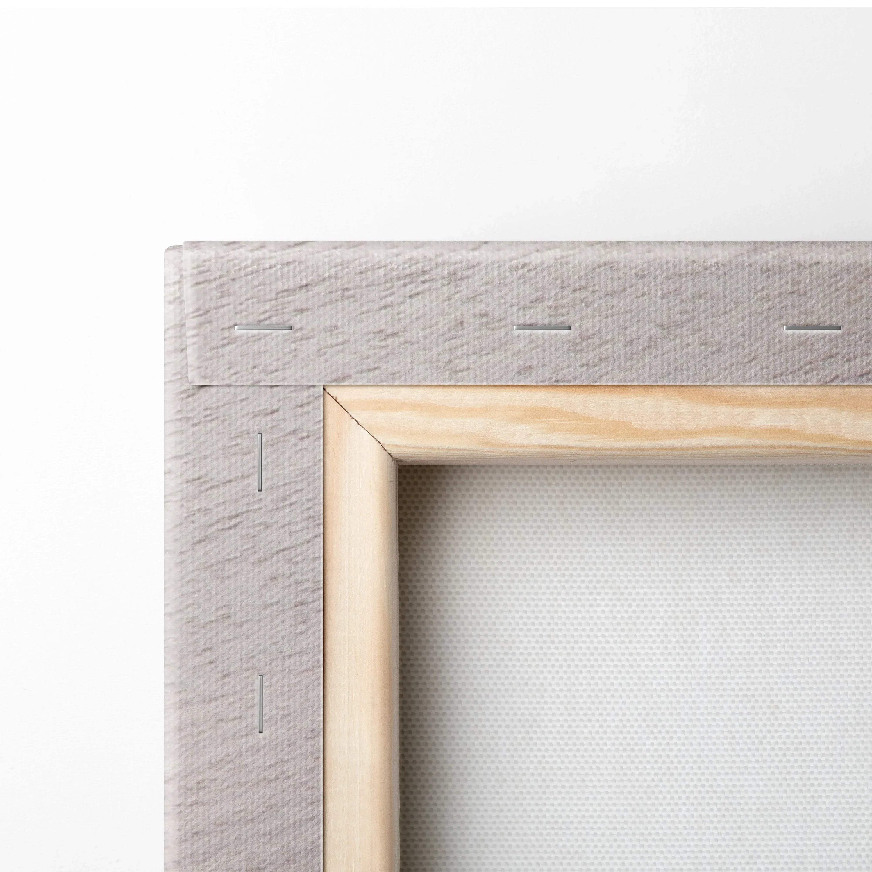 Close-up of natural wood frame and textured beige canvas for wall art decor.