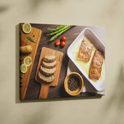 Canvas wall art featuring a lunch table scene with grilled salmon, sliced bread, cherry tomatoes, asparagus, and lemon.