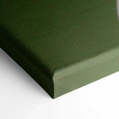 Close-up of green canvas wall art corner with textured fabric for home decor.