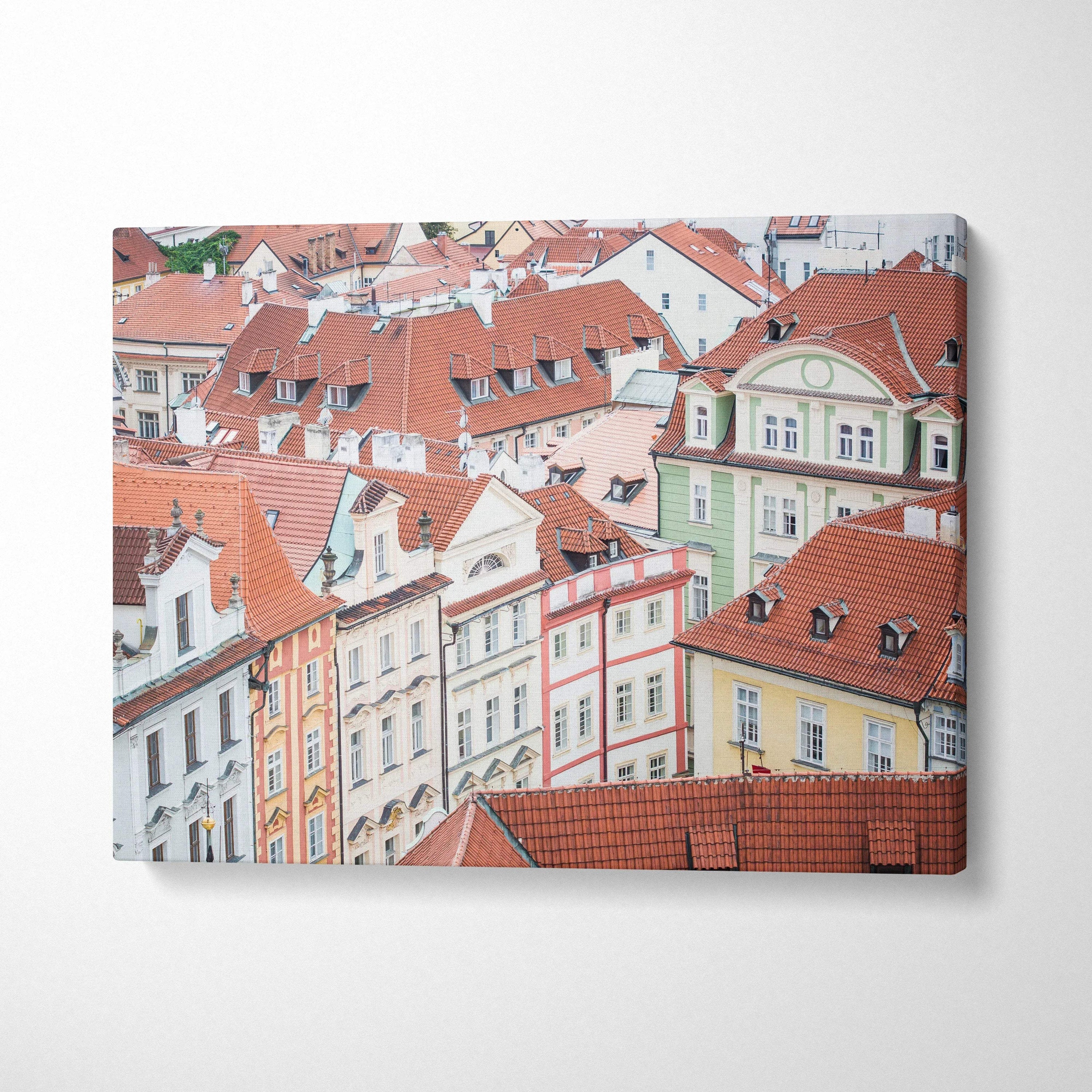 Canvas wall art featuring detailed pastel-toned European rooftops and historic buildings.