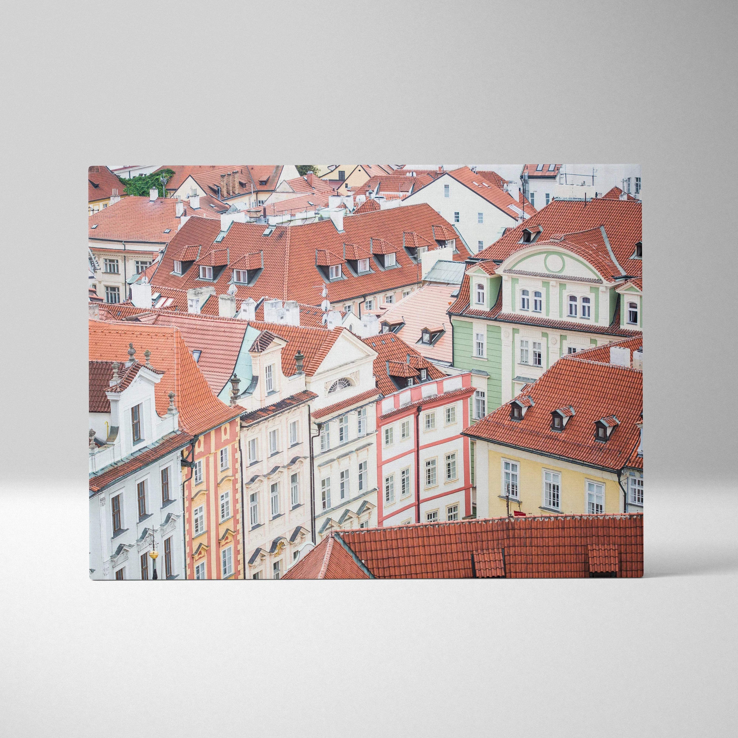 Canvas wall art featuring detailed digital art of colorful European-style buildings with red rooftops and intricate facades.