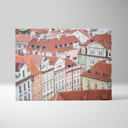 Canvas wall art featuring detailed digital art of colorful European-style buildings with red rooftops and intricate facades.