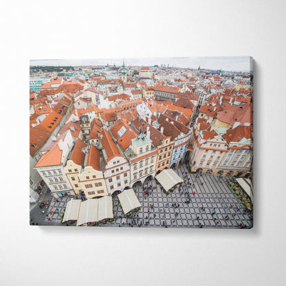 Panoramic canvas wall art depicting a European cityscape with red-tiled roofs and historic buildings above a busy square.
