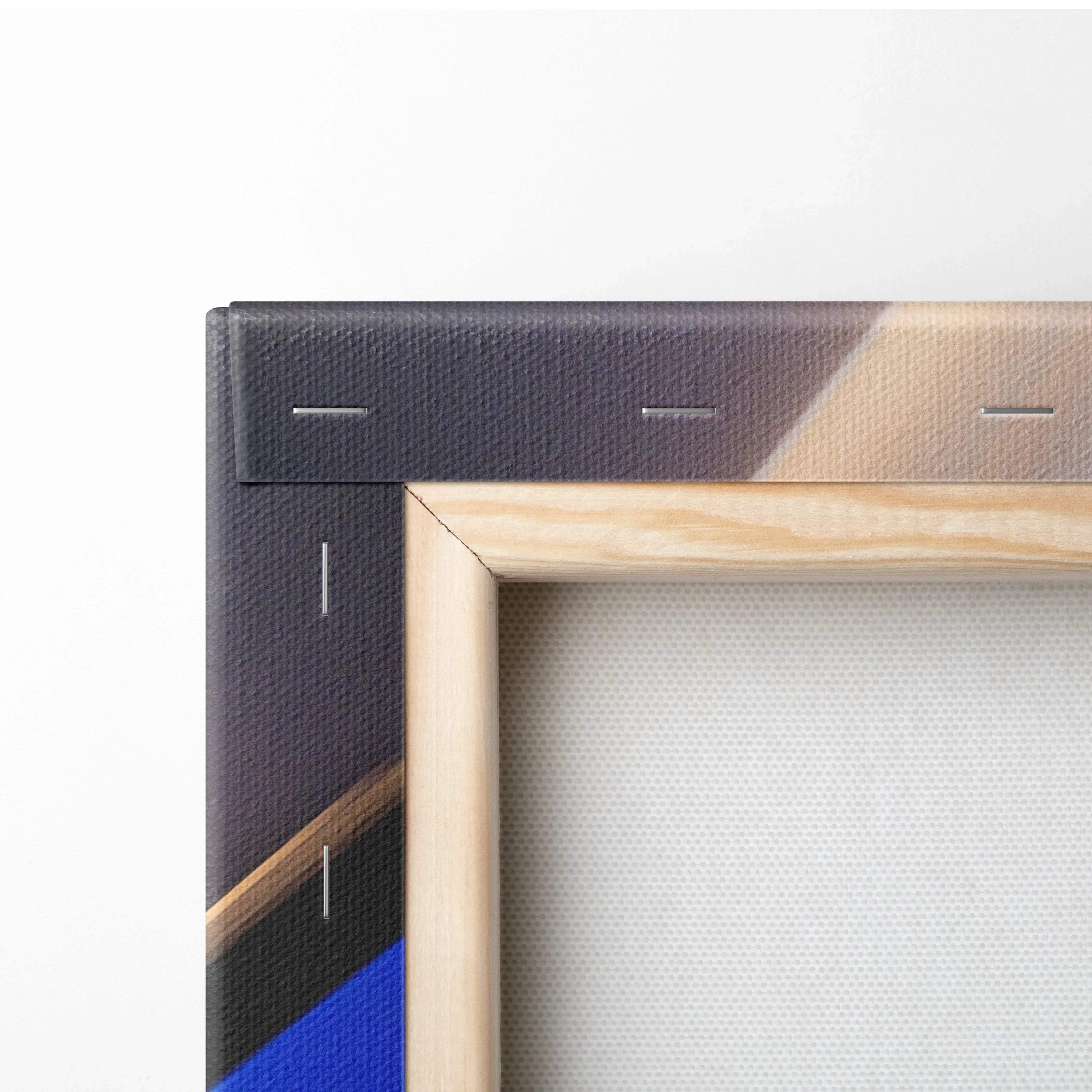 Close-up of vibrant abstract digital canvas art with bold blue, beige, and black geometric shapes on wood frame.