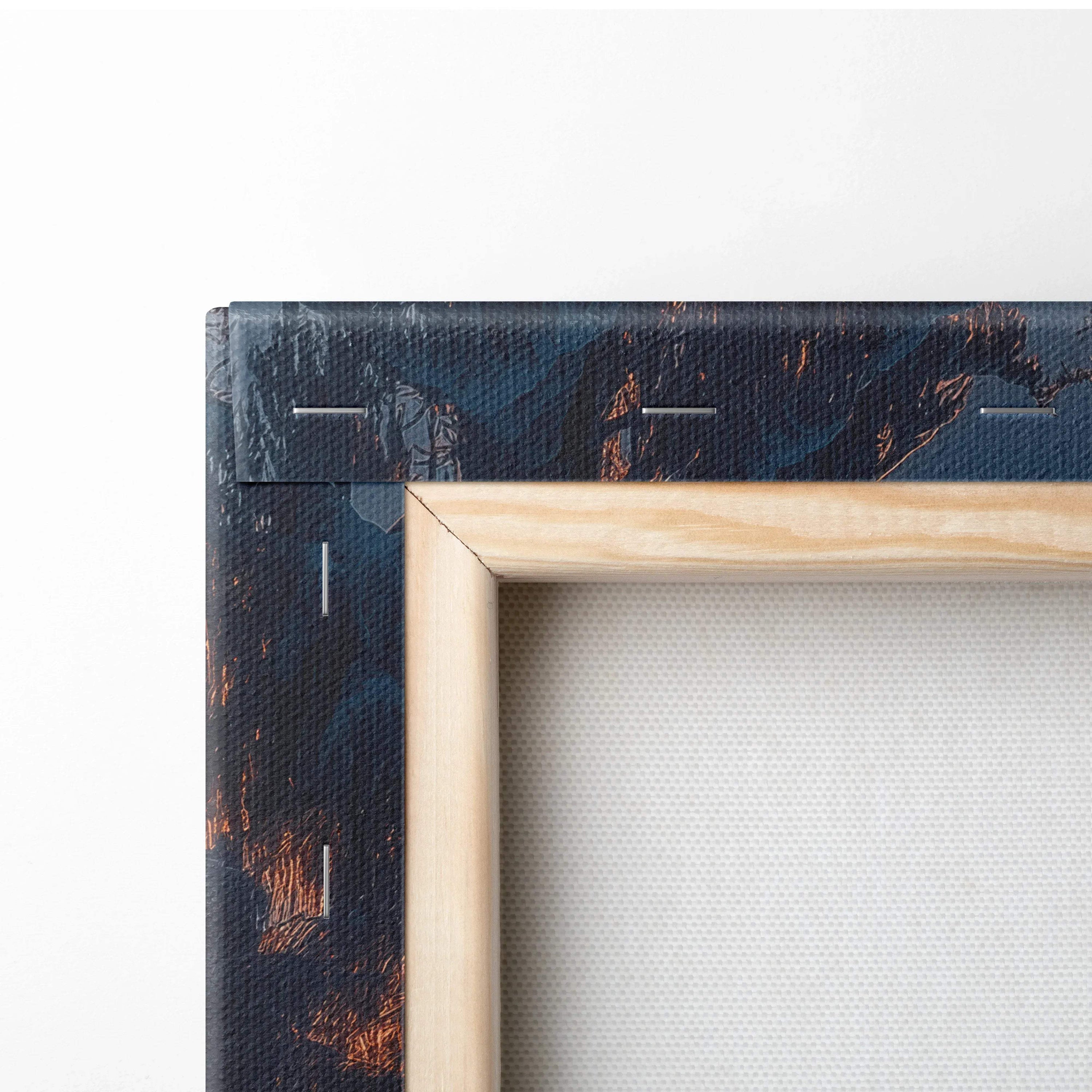 Close-up of natural wood frame corner on premium canvas wall art with textured dark snowy winter landscape decor.
