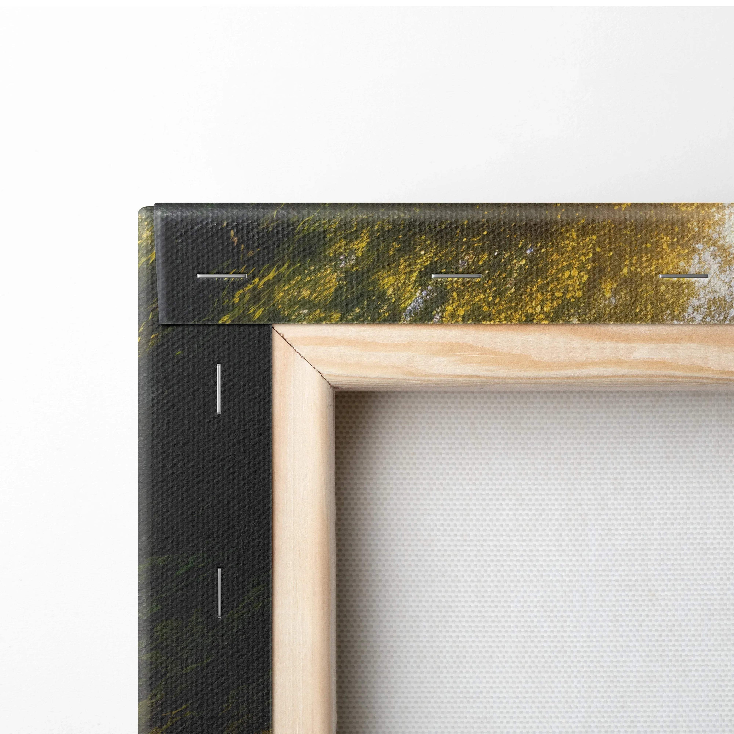 Close-up of wooden frame and stapled edge of forest sunset waterfall canvas wall art decor.